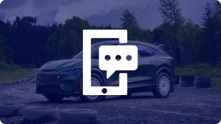 A green Ford Mustang Mach-E sitting on a dirt road with trees in the background with mobile phone and text icon overlaid
